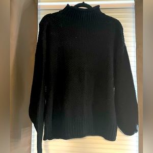 Black turtleneck with batwing sleeves